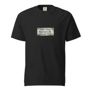 Black t-shirt with a white label and printed text in the center.